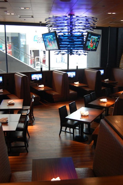 Two chandeliers made from 500 hockey sticks hang in an area called the Coaches Corner, where every booth is equipped with its own television.