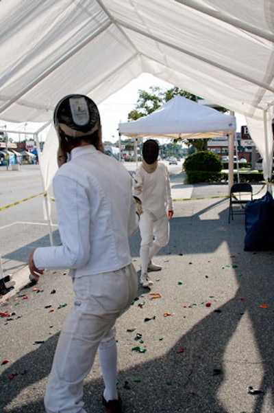 A fencing game had participants trying to pop balloons on top of their opponents' helmets.