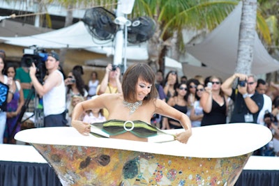A burlesque dancer performing in a basin tub kicked off the A.Z. Araujo show on Sunday night at Nikki Beach.
