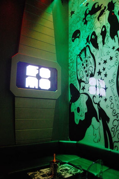 The FOMO logo is displayed on a screen inside an oversize watch, which hangs on the wall opposite the bar.