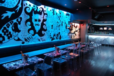 Artwork by French artist Fabien Verschaere decorates a wall and tabletops.