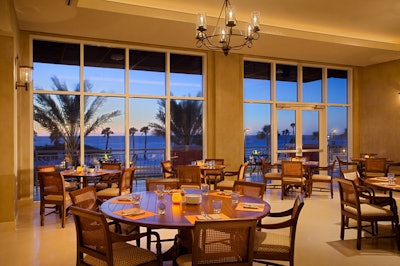 Shor's dining room features floor-to-ceiling windows along one wall overlooking the Gulf of Mexico.