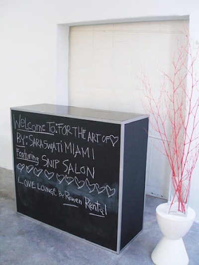Multiple chalkboard bars from Ronen Bar and Furniture Rental can be lined up next to one another to create a graffiti-style wall for guests to sign.