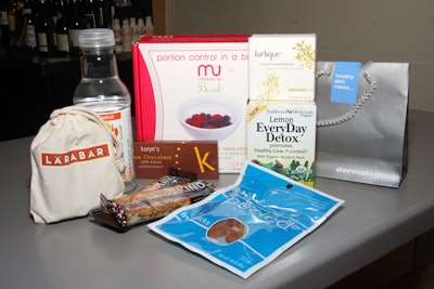 Items in the bag included detox tea, raw chocolate bars, facial cleanser, and citrus-scented silk finishing powder.