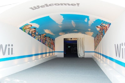 Nintendo applied Wii branding and Mii (the digital characters created by users) graphics to many areas of the site, including the tent's tunnel-like entrance hall.