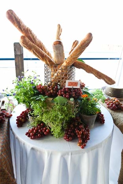 A spread of grapes, baguettes, and potted flowers accented the catering buffets.