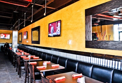 Havana's Cuban Cuisine's dark wood tables and black banquettes are accented by bright yellow walls and colorful artwork and linens.