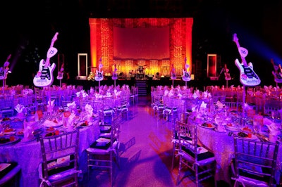 The Hard Rock event team used sparkly silver linens from Over the Top Party Rental Linens to adorn the tables and reflect the colorful lighting in the arena.