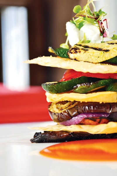 Grilled vegetable napoleon of eggplant, yellow squash, zucchini, peppers, mushrooms, and phyllo dough with roasted red pepper sauce and goat cheese from Phil Stefani Signature Events in Chicago.