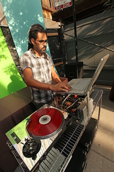 DJ Lonnie Bonds spun songs from artists such as Ray Lamontagne. Behind him, towering pieces of dry wall bore the same bright colors as the stripes on the bakery's facade.