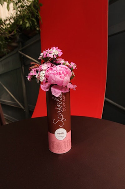 On high-top tables that flanked the sidewalk, cupcake-mix canisters held pink peonies.