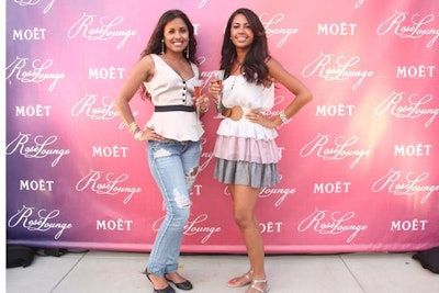 Attendees were encouraged to have their pictures taken at the step and repeat near the rooftop entrance.