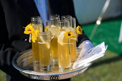 As guests arrived, servers offered trays of cold drinks garnished with summer flowers.