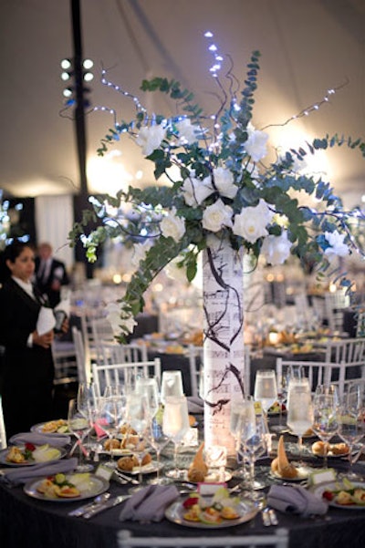 Kehoe's centerpieces incorporated lit-up branches, white roses, and silver dollar vines.