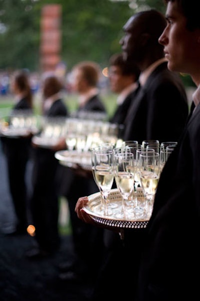 At the entrance to the dinner tent, a line of servers offered flutes of champagne.