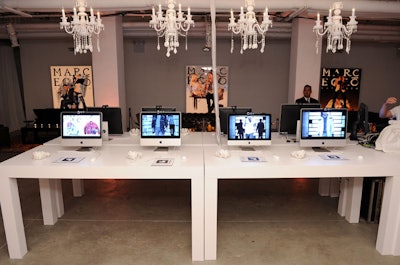 White tables held eight computers set up for guests to play with the augmented reality technology.