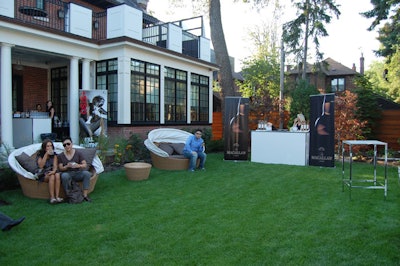 Banners bearing logos of event sponsors like Macallan and Stolichnaya flanked three bars in the backyard.