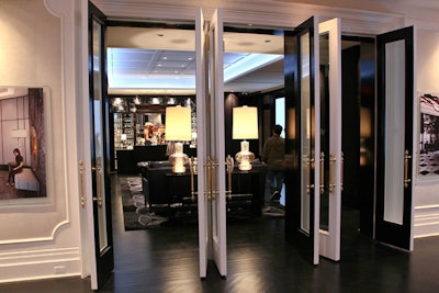 Glass engraved doors with brass handles mark the entries between each room within the presentation centre.