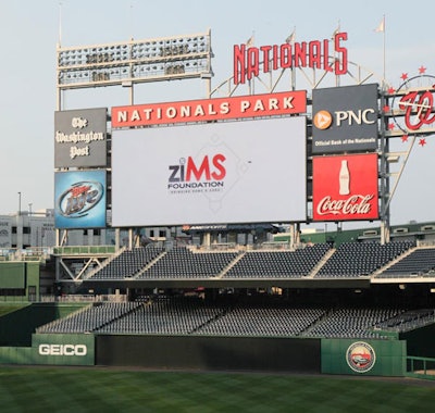 The high-definition scoreboard displayed live shots and Zims Foundation branding.