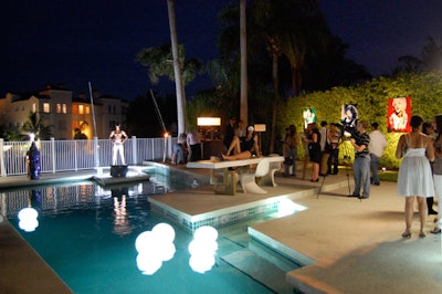 Masked models lounged on furniture set up on the pool deck.