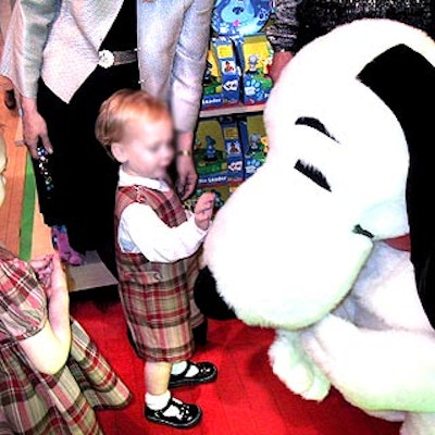 At the Society for Memorial Sloan-Kettering's Bunny Hop event at FAO Schwarz, a young guest cautiously approached an actor dressed as Snoopy.