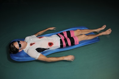 A model with fake gunshot wounds floated in the pool like a dead body.