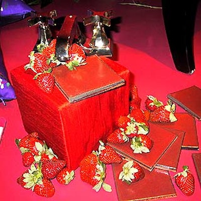 At House & Garden magazine's Color Makes a Difference silent auction benefit, Frederick Anderson of Anderson Hannant displayed a Kohler faucet and Ann Sacks tiles on a cube covered in red raw silk with fresh strawberries scattered around it.