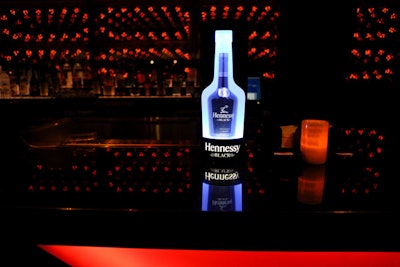 Event sponsor Hennessy Black decorated Haze's bars with illuminated bottles.