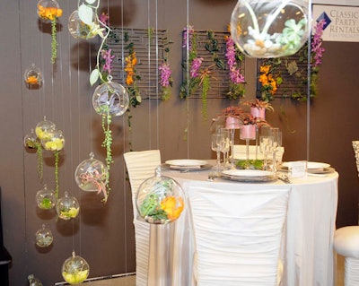 Classic Party Rentals divided its booth with a so-called 'flower wall' comprised of hanging terrariums from its inventory.