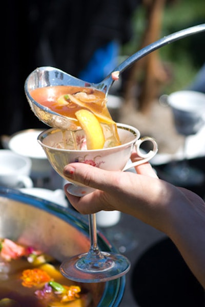 Guests ladled flower-and-fruit-filled punch into teacups with martini-glass stems.