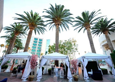Cabanas and existing palm trees added to the party's poolside lounge feel.