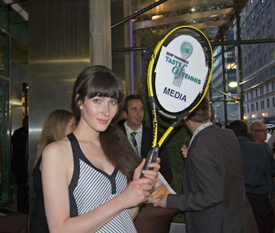 At the Taste of Tennis event, staffers with racket-shaped signs guided guests to the correct check-in areas.