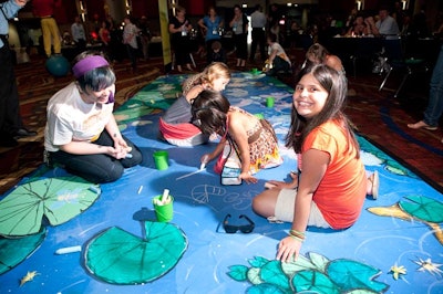 Employees could bring their children to the event, where activities included chalk drawing on a fake sidewalk.