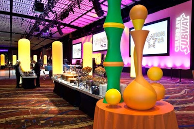 Decor in the Clubway included yellow, green, and orange glow spheres atop fabric-skirted platforms. The color scheme nodded to the hues of the Subway logo.