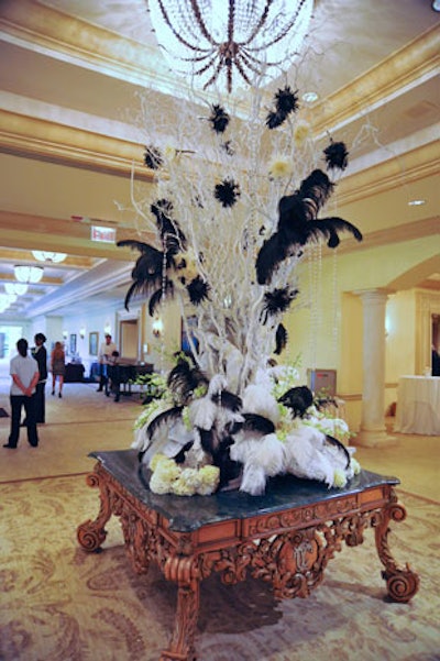Blooming Design and Events used painted white trees adorned with white and black plumes in lieu of floral arrangements.