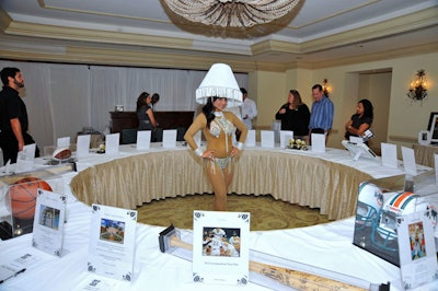 Models in flesh-toned body suits and lamp-shade headpieces served as the centerpieces for the silent auction tables in a designated area near the cocktail reception.