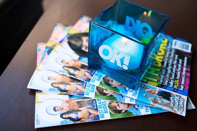 Logo candle holders sat atop stacks of magazines.