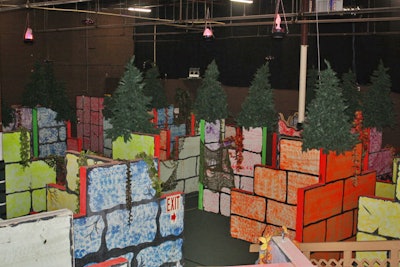 The laser tag course reflects the facility's name—the Woods—complete with faux trees, pretend fire, and the sound of crickets.