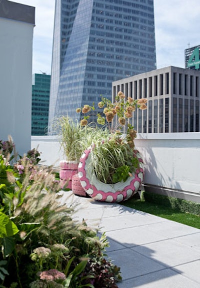 Stacked tires function as planters on the United States of Tara roof, pieces created by Amanda Mitchell and Karl Friedrich of Brooklyn-based Jungle Design. The space channels Tara's feminine housewife personality with Astroturf and plantings, and her teenage persona via playful colors and the surreal elephant topiary.