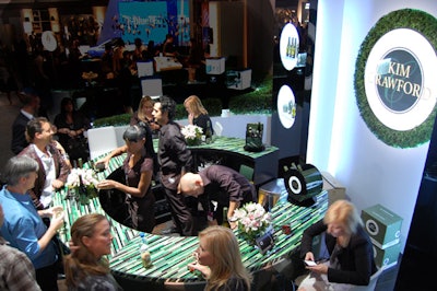 Produced by Grand Central Marketing, the bar and lounge section for New Zealand winemaker Kim Crawford complemented the hedges in the space with a green color scheme and wreathlike backdrop. As the company was not allowed to serve wine until after 2 p.m., the booth provided hand massages in the morning. Organizers estimate more than 2,700 sample glasses of wine were poured per day.