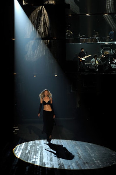 Yohji Yamamoto's Y-3 collection for Adidas blended sportswear with the designer's homage to classic rock. Playing with shadows and darkness, the Sunday afternoon showing at the Park Avenue Armory included a mirrored backdrop—tilted toward the bleachers where the audience sat—as well a stage for the Duke Spirit, which performed during the show.