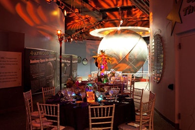 Orange and purple projections of palm leaves illuminated the walls around the dinner tables.