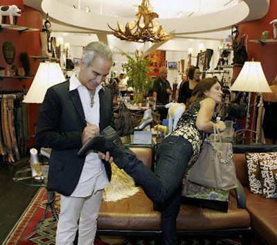 Donald J Pliner signed a shopper's shoe at the Forum Shops for Fashion's Night Out, in one of many chances for customers to engage with personalities and other in-store promotions.