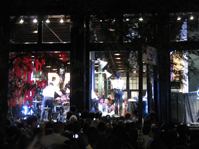 Throngs of people crowded West Broadway's sidewalk and road outside the Ralph Lauren shop, where singer Janelle Monae performed in the windows.