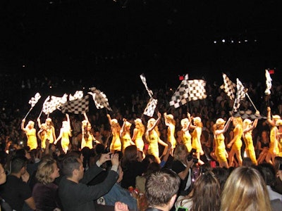 Betsey Johnson's show finished with a procession of models in cyclist gear, all waving checkered flags.