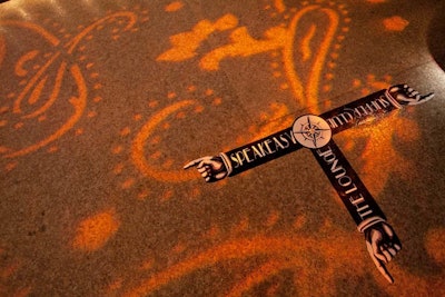 Vintage-inspired floor decals helped guide guests through the event's various areas, and paisley-patterned projections added texture to the site of the New York party.