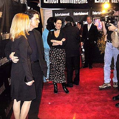 Celebrity wrangler Lori Levine (center) watched as actor Peter Gallagher and his wife, Paula Harwood, posed for photographers outside Entertainment Weekly's Oscar party at Elaine's.