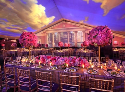 Towering spheres of roses decorated dinner tables.