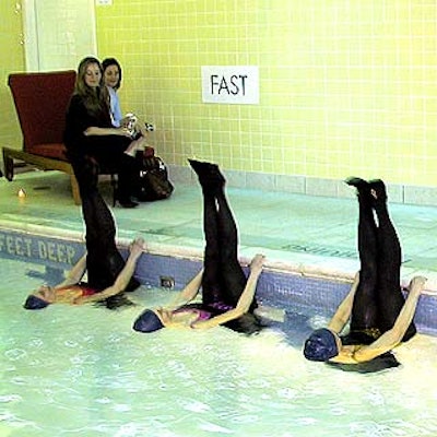 Dressed in retro black swimsuits, tights and heels, synchronized swimmers from Waterworks performed in the club's basement lap pool.