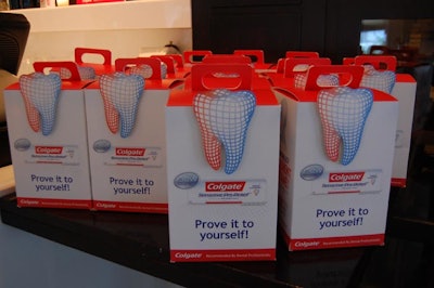 Branded gift boxes included product samples from Colgate, a toothbrush, and a water bottle.